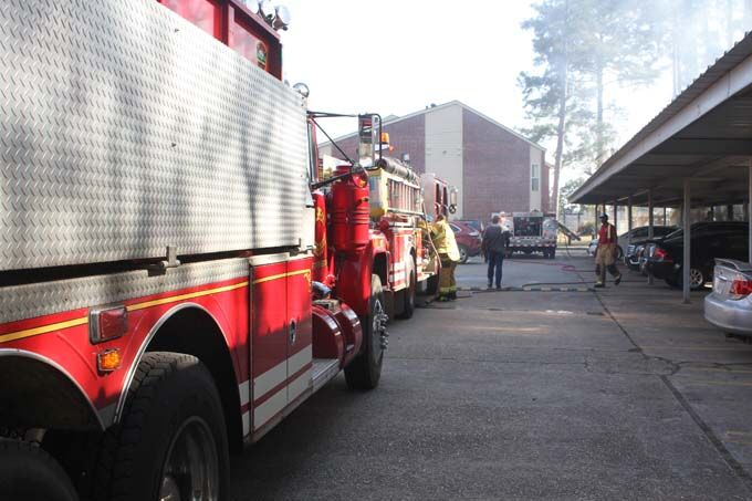 Firemen stop out of control fire before it reaches apartments and ...