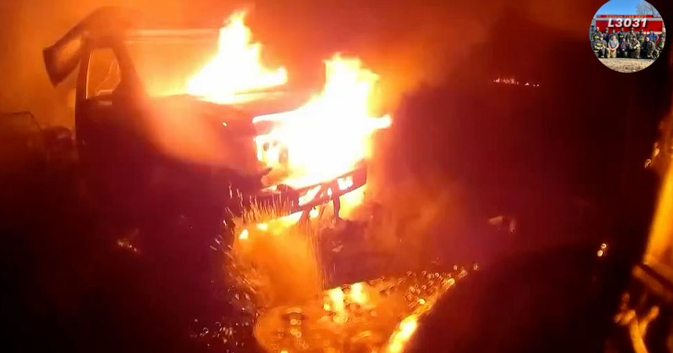 Helmet-Cam: Nevada Firefighters extinguish RV fire threatening building