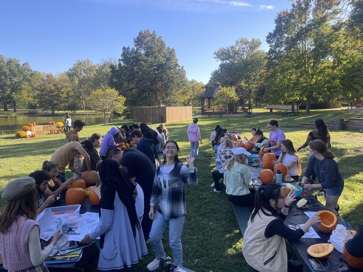 Photo of Coatesville students posing with pumpkins carved with