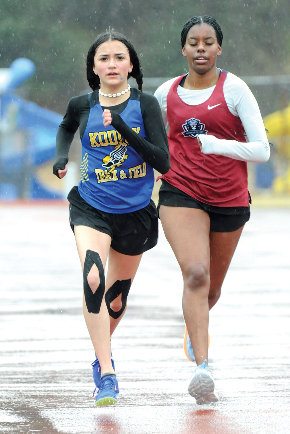 Track athletes greeted by rain, wind on The Rock | Local Sports ...