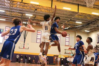 James Lee goes for the basket past Hickman’s Langston Stroupe