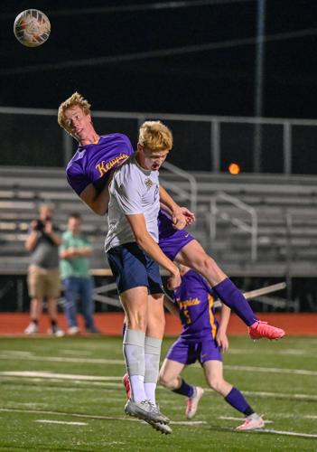 Liam Coon (24) headbutts the ball ahead Tobias White (12)