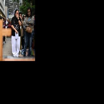 Filipinas in Hong Kong take part in a prayer service for victims of the Tai Po fire. At least 10 of the 146 killed were migrant workers