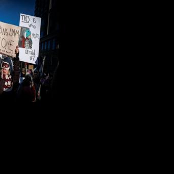 People hold signs in reference to five-year-old Liam Conejo Ramos who was held by immigration officers, during the "ICE out of Minnesota: Day of Truth and Freedom" protest in Minneapolis, Minnesota on January 23, 2026