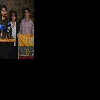 Ramon Guanipa, son of former National Assembly vice president Juan Pablo Guanipa, speaks to reporters following his father's re-arrest in Caracas