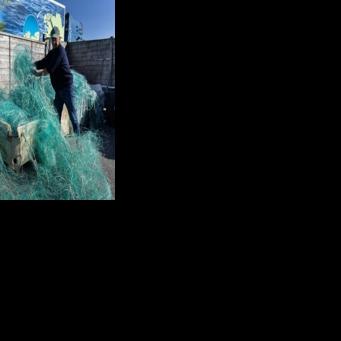 French charity association Kernic Solidarites members Christian Abaziou (R) and Gerard Le Duff (L) sorted fishnets collected by the association to be sent to Ukraine for use against drone attacks