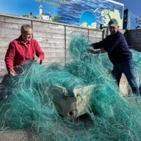 French charity association Kernic Solidarites members Christian Abaziou (R) and Gerard Le Duff (L) sorted fishnets collected by the association to be sent to Ukraine for use against drone attacks