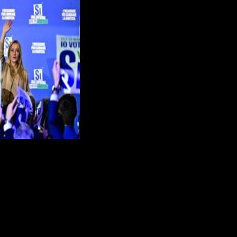 Italy's Prime Minister Giorgia Meloni waves to supporters at the end of a campaign meeting