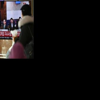People watch a television screen showing a live broadcast of the trial verdict of South Korea's former prime minister Han Duck-soo (L on the screen) on charges related to martial law, at a train station in Seoul on January 21, 2026