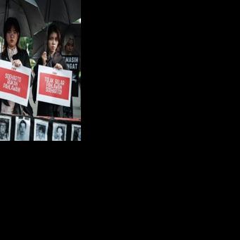 Activists protest the decision to name former dictator Suharto a national hero