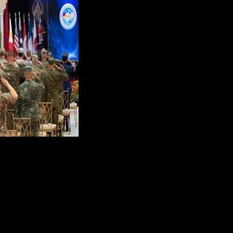 Philippine and US soldiers salute as their national anthems are played during the opening ceremony of the annual Balikatan military exercise at Camp Aguinaldo in Manila on Monday
