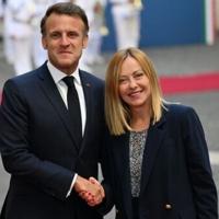 Italy’s Prime Minister Giorgia Meloni (R) shakes hands with France's President Emmanuel Macron in Rome
