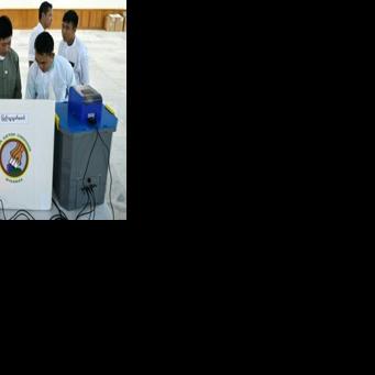 Members of Myanmar's Union Election Commission demonstrate a voting machine during the UEC's first major press conference in Naypyidaw on September 11, 2025