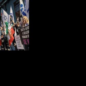 Supporters of Israel and Iranian pro-democracy activists chant slogans and hold flags in Cape Town