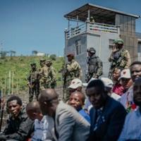 M23 rfighters stand guard during a service organized by rebels' administration at a stadium in Goma on May 18, 2025