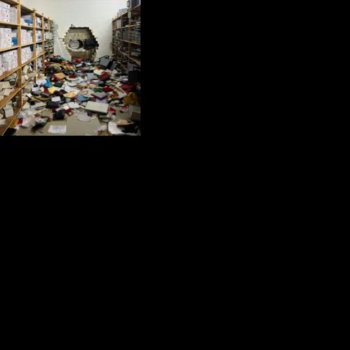 A giant hole in the wall of the bank vault, shown in a photo released by German police