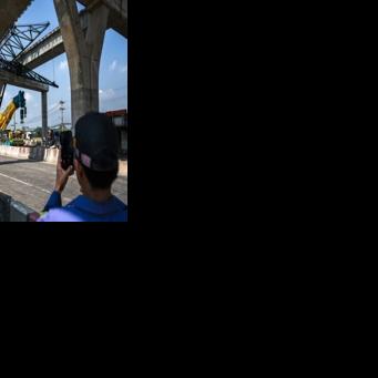 A highway construction crane collapsed near Bangkok on Thursday, killing two people, with Thailand's transport minister saying the firm involved was the same one whose machine fell at a China-backed rail project the day before, when 32 died