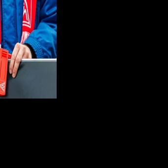 A VW employee wearing an IG Metall union scarf at a rally in eastern Germany