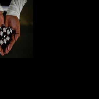 A health ministry worker showing vaccine doses for an immunisation campaign in Guatemala