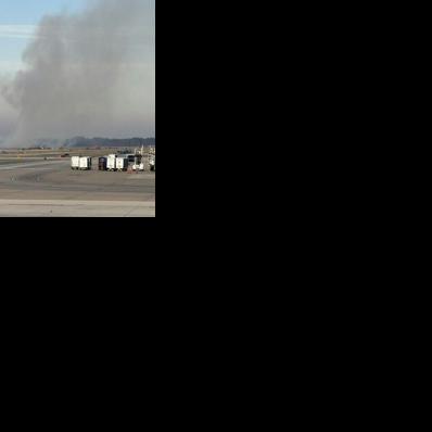 Brush burns near a runway at Dulles Airport outside Washington after a plane experienced engine failure during takeoff 