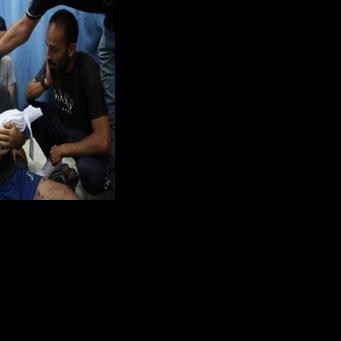 A Palestinian man mourns his 6-month-old son, killed in a reported Israeli strike on Gaza City