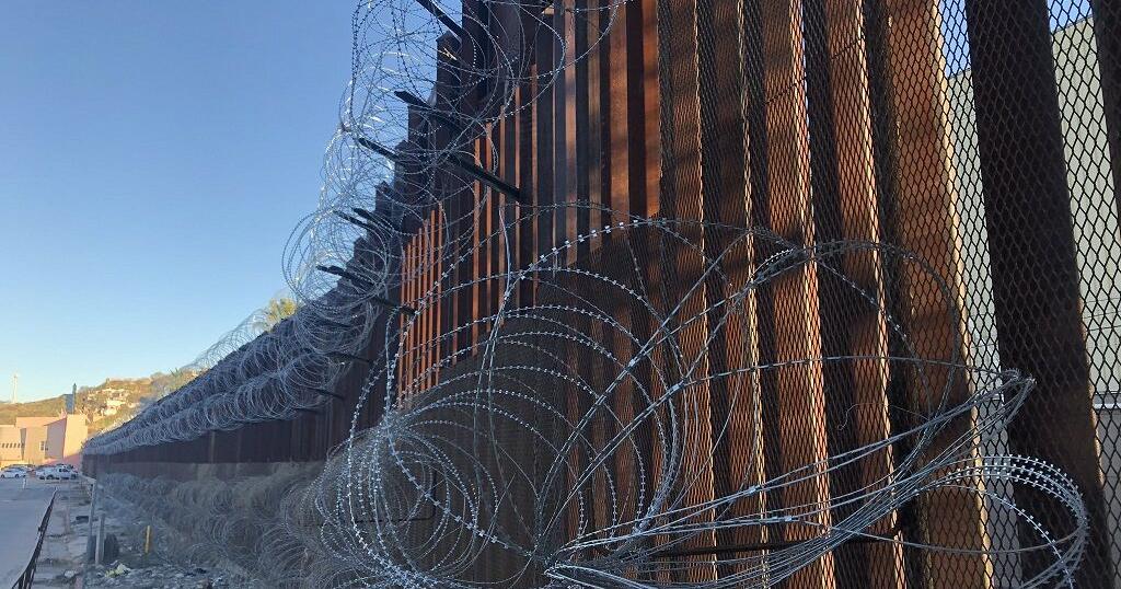 Razor wire still attached to Nogales border fence