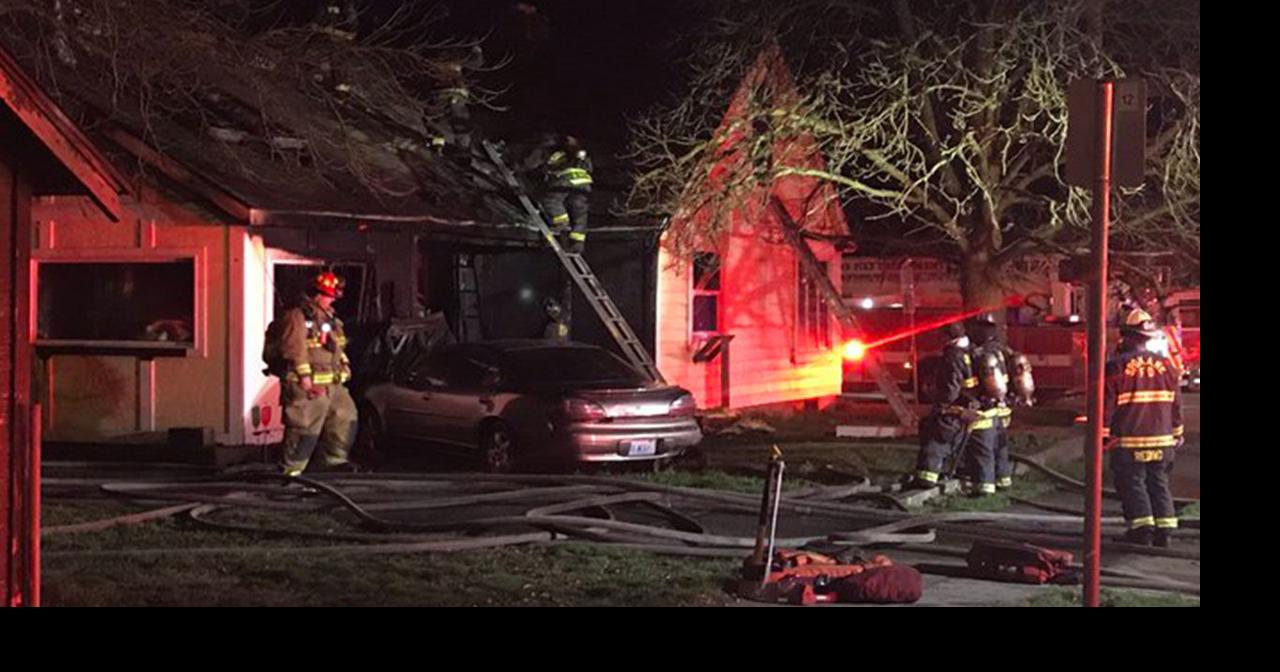 Crews knock down house fire sparked by car crash in east Spokane ...