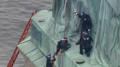 Statue of Liberty protester charged for ‘dangerous stunt’ | National ...