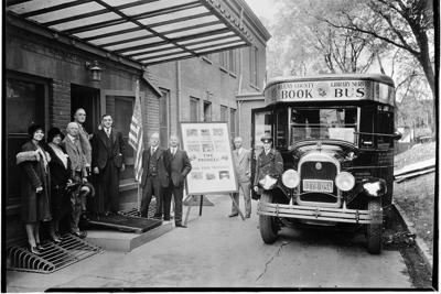 President-elect Franklin D. Roosevelt stands with a Queens book bus in 1932.
