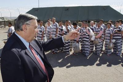 Maricopa County Sheriff Joe Arpaio orders undocumented immigrants handcuffed together and moved into a separate area of Tent City in Phoenix on Feb. 4, 2009.