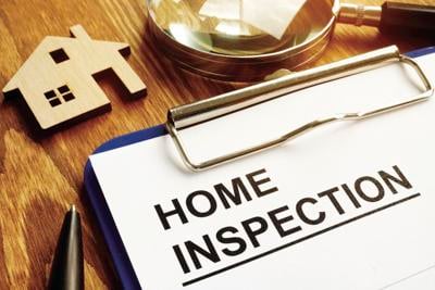 Home inspection form with clipboard and pen.