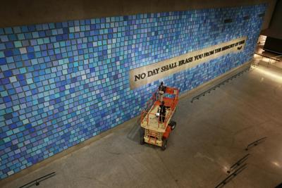 'No Day Shall Erase You From the Memory of Time,' a phrase written by the Roman poet Virgil, is displayed on a wall at the 9/11 Memorial Museum.