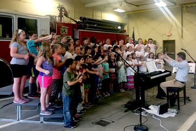 Pleasant Street School second-graders serenade city firefighters