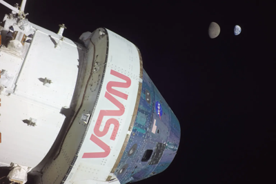The Artemis I crew and service modules with the Moon and Earth in the distance on Nov. 28, 2022.