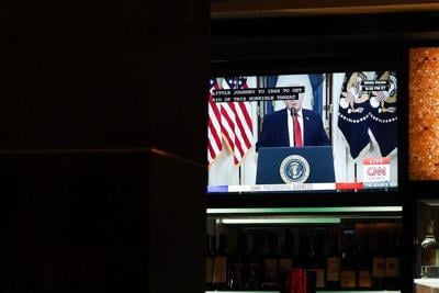 A TV displays U.S. President Donald Trump's prime-time address on the war in Iran inside a Cheesecake Factory on April 1, 2026, in Washington, D.C.