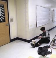 Volunteers paint hallways at Paul Smith School