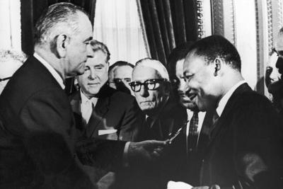 President Lyndon Johnson hands a pen to civil rights leader Rev. Martin Luther King Jr. during the signing of the Voting Rights Act in Washington,  D.C., on Aug. 6, 1965.