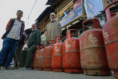 Customers stand with empty cooking-gas cylinders in Srinagar, India, waiting to be able to refill them.