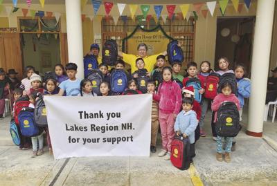 03 COM backpacks donated