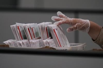 A worker inspects a ballot the day after California's primary election at the Los Angeles County Ballot Processing Center on June 3, 2026.