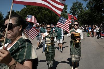 A Laotian heritage group participates in an Independence Day parade in Iowa. Communal celebrations like this can foster belonging.