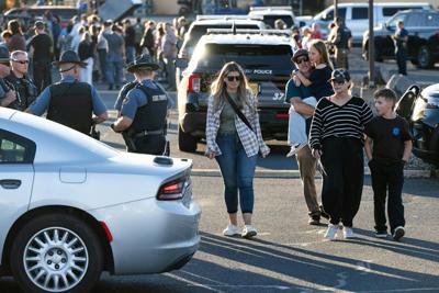 People leave a family meeting area following a shooting at Silver Rail Elementary School on Oct. 15, 2026, in Bend, Ore.