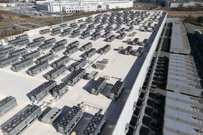 An aerial view shows cooling vent fans on the roof next to generators on the lower level of a data center in Ashburn, Va.