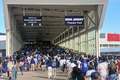 Under the watchful eye of surveillance cameras, fans leave after the France-Senegal World Cup match in East Rutherford, N.J., on June 16, 2026.