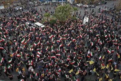 A group of demonstrators in Tehran wave Iranian flags in support of the government on Feb. 28, 2026 AP Photo/Vahid Salemi