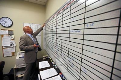 A court interpreter checks the day's schedule of assignments.
