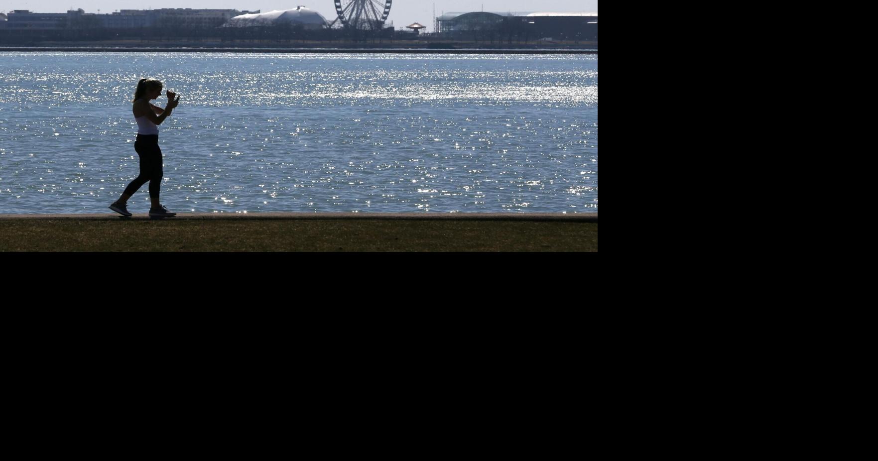 A person walks the trail along Lake Michigan at Chicago's North Avenue Beach.