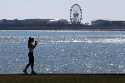 A person walks the trail along Lake Michigan at Chicago's North Avenue Beach.