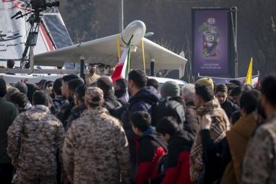 Revolutionary Guard personnel stand under an Iranian-made unmanned aerial vehicle, the Shahed-136, while participating in a military rally in Tehran, Iran, on Jan. 10, 2025.