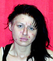 Woman charged in stabbing